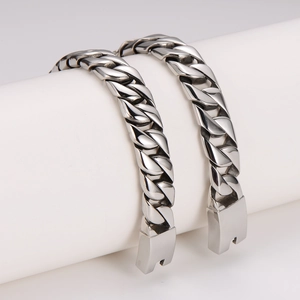Chunky stainless steel Cuban link bracelet for men with polished finish on white stands
