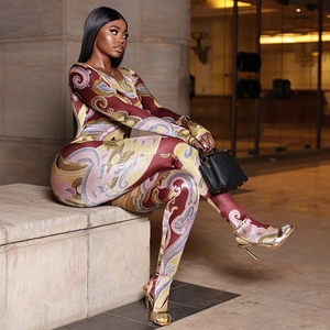Slim fit long sleeve jumpsuit with abstract swirl print in warm tones for women