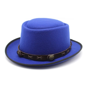 Detailed view of the bright blue wool felt jazz hat with brown leather band and studs