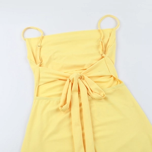 Detail of yellow tube dress with adjustable straps and decorative back ribbon bow knot
