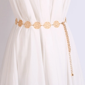 Golden metal waist chain with hollow circle links worn on white dress, fashion accessory