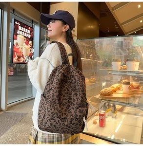 Detailed view of leopard print corduroy texture on a casual urban school backpack