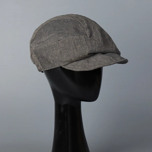 Detailed texture of gray linen fabric on a vintage newsboy cap with short brim style