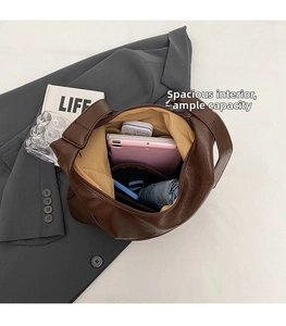 Spacious interior of coffee brown leather tote bag showing large storage capacity