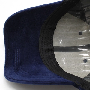 Detail view of navy velvet baseball cap with reinforced stitched brim and inner sweatband