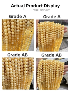 Detailed comparison of Grade A and Grade AB yellow topaz beads with a polished finish