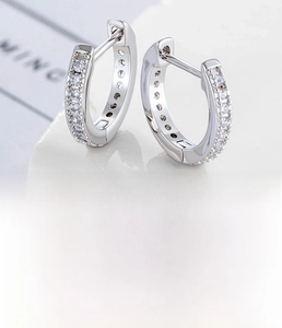 Macro detail of silver copper hoop earring with inlaid zircon showing 10mm inner diameter