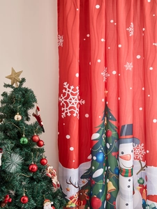 Detail of red Christmas snowman curtain with snowflake patterns in festive room setting