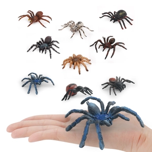Set of 10 realistic spider toy models with large blue spider shown in hand for scale