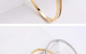 Detailed close-up of gold and silver hinged bangles with sparkling paved crystals
