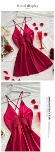 Detail of burgundy satin nightgown featuring deep V-neckline and intricate lace patchwork