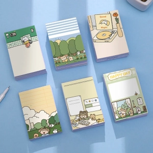 Flat lay of six cute cartoon mini notepads with cat and bear illustrations for students