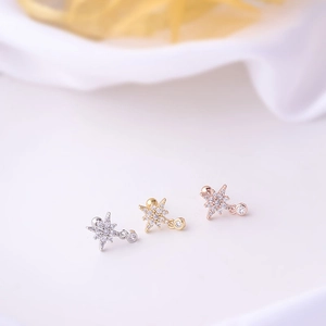 Detailed close-up of star-shaped 20G surgical steel studs in silver, gold, and rose gold