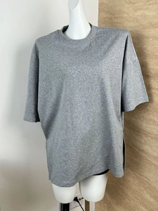 Detail of dark grey oversized knit cotton T-shirt with batwing sleeves and side slits