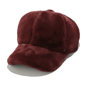 Detail shot of plush wine red faux fur texture and stitching on winter baseball cap