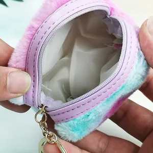 Detail view of gradient plush coin purse showing the purple zipper and white fabric lining
