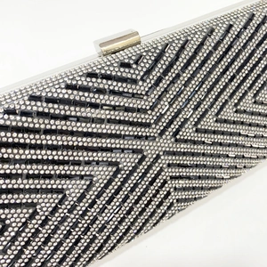 Elegant evening clutch bag with V-shaped rhinestone stripes and silver metal clasp