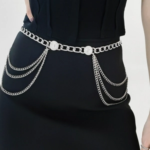 Detail of silver multi-layer metal waist chain with fringe tassels and coin pendants
