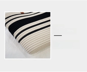 Detail magnification showing the fine stitching and black-and-white woven cotton pattern