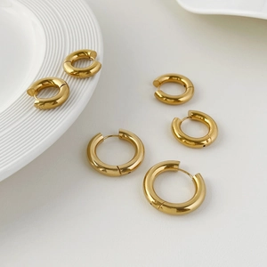 Three pairs of gold stainless steel hoop earrings in small, medium, and large sizes