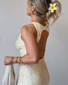 Detailed back view showing the open back design and intricate lace texture of the dress