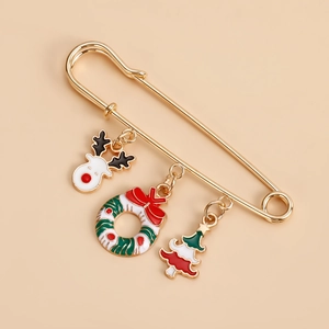 Detailed view of golden Christmas brooch featuring reindeer, wreath and tree charms
