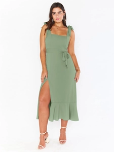 Detailed view of green maxi dress featuring a high side slit and ruffled hemline