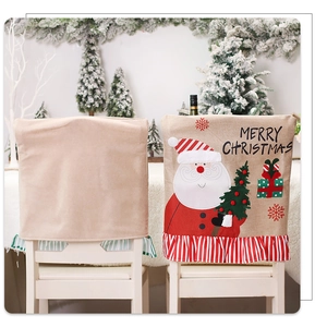 Detail of burlap Christmas chair cover with Santa embroidery and red striped ruffle