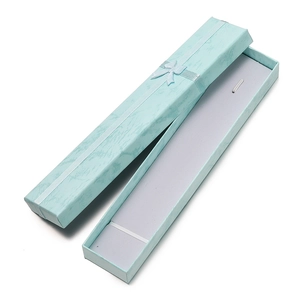 Detailed view of light blue marble jewelry gift box with ribbon and velvet lining