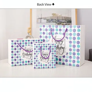 Three-piece set of polka dot Happy Birthday gift bags with purple woven handles
