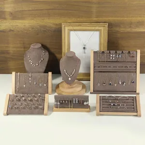 Elegant solid wood jewelry display stand with golden rings, earrings and necklaces