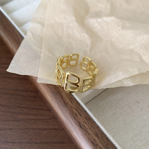 Golden 925 sterling silver open ring featuring hollow letter B motifs in a warm setup