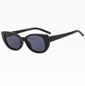 Side view of cat-eye sunglasses with glossy black frames and dark grey lenses