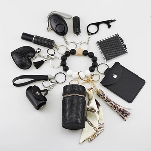 All-in-one black self-defense keychain set with alarm, wristlet, and stylish charms.