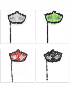 Detail view of sequined masquerade masks with hand-held sticks in four vibrant colors