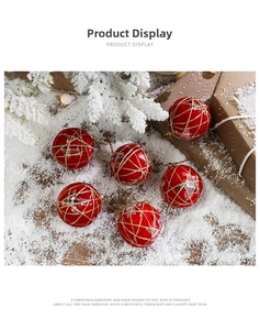 Detail of red fabric Christmas ball ornaments with snowflake patterns and rustic twine cord
