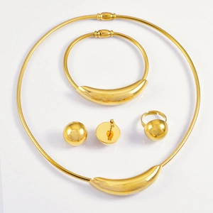 Elegant 4-piece gold jewelry set including curved necklace, bracelet, ring and ball earrings