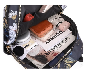 Internal view of floral backpack showing large capacity for laptop and daily essentials