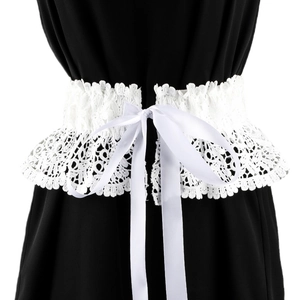 Detail of white floral lace corset belt with satin ribbon ties over a black dress