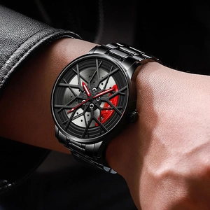 Close-up of men's wheel hub watch with red brake caliper dial and black steel strap