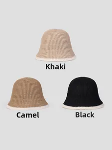 Three knitted bucket hats in khaki, camel, and black with white contrast trim details