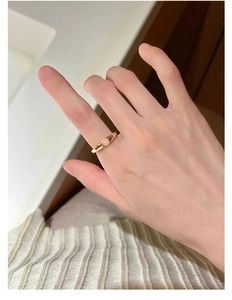 Detailed view of an S925 silver ring with golden finish and pink gemstone