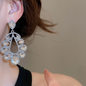 Detailed macro view of elegant silver teardrop drop earrings with sparkling rhinestones