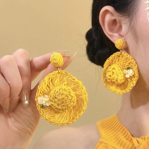 Handcrafted yellow raffia straw hat earrings with white floral accent for beach vacations