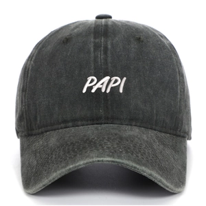 Macro shot of high-quality white PAPI 3D embroidery on washed black cotton baseball cap