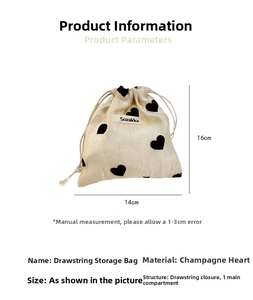 Detailed view of 14x16cm drawstring storage pouch with black heart print on beige fabric