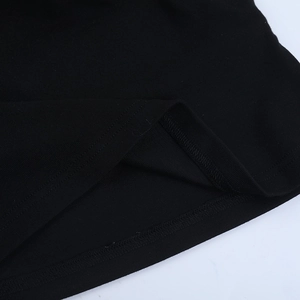 Detailed close-up of the black knit fabric hem and fine double-needle stitching quality