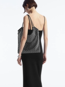 Elegant black checkered tote bag for women shown with a model on a white background