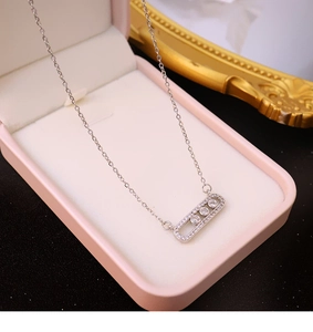 Close-up of zircon paperclip necklace with sliding diamonds in a luxury jewelry box