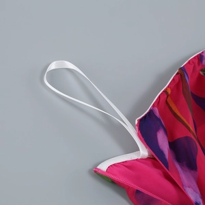 Detail of floral chiffon fabric featuring fuchsia print and white shoulder strap loops